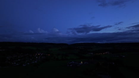 horizon of deep blue and cloud impose over small village below