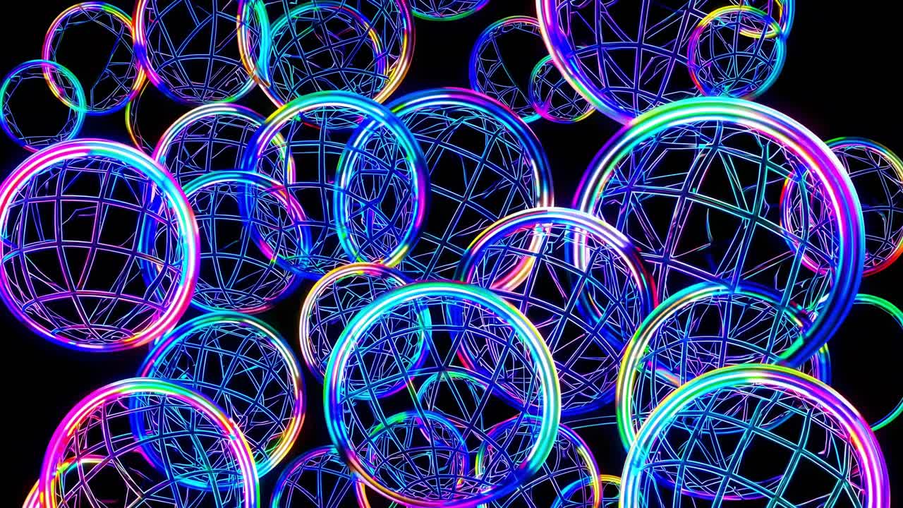 Colorful glowing spheres with intricate wireframe designs float dynamically against a dark background, creating a mesmerizing visual sequence of motion and light