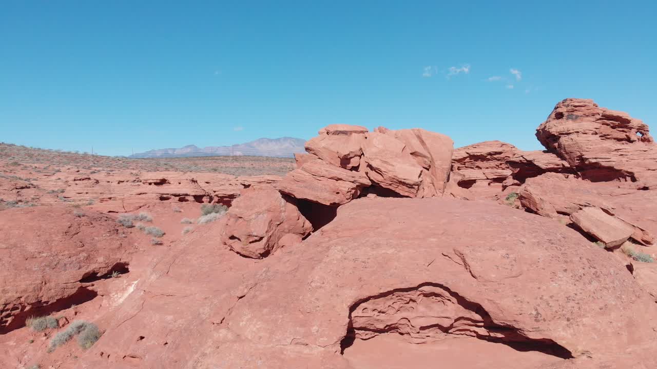 Drone che si alza sopra una roccia rossa.