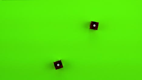 red dice rolling craps (double ones) on green screen