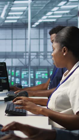 vertical video cybersecurity experts in server farm trying to protect equipment from hacker