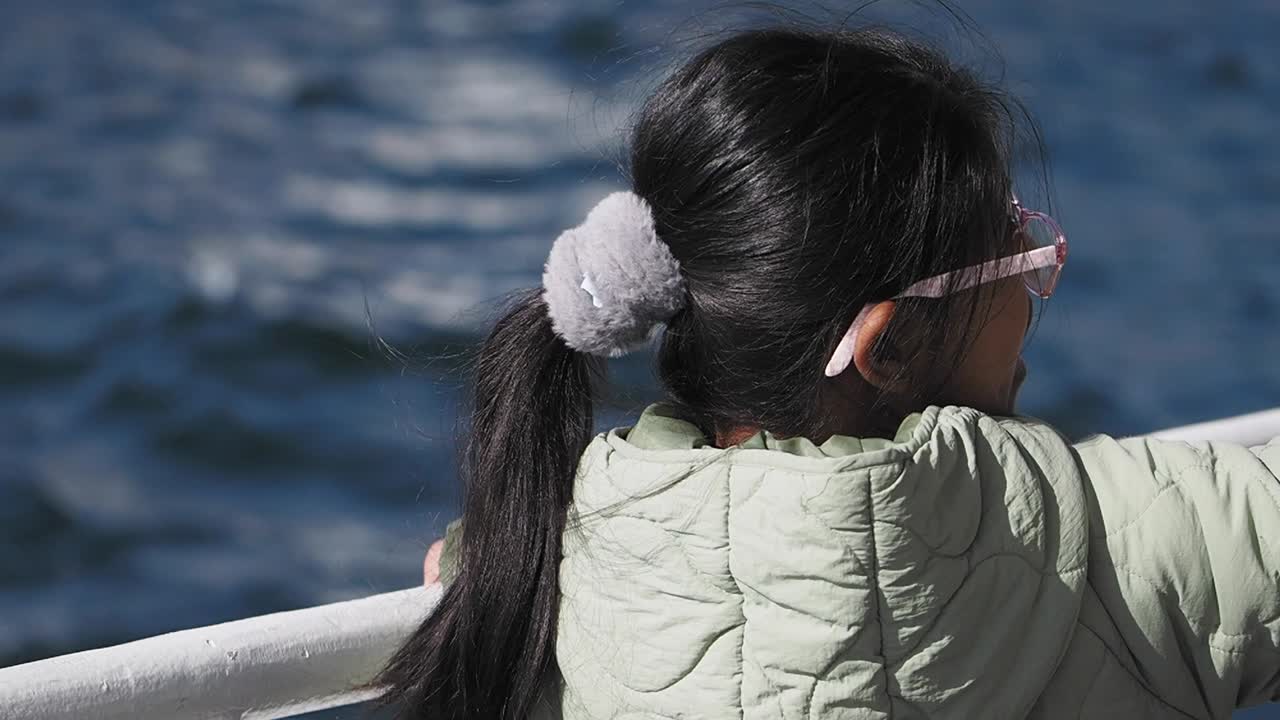 Girl looking at the ocean from a boat