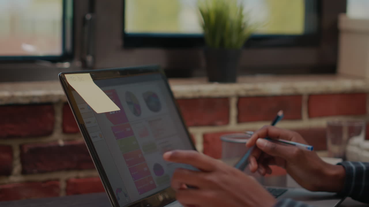 Business man putting adhesive post it paper on laptop display