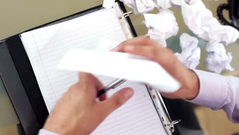 young frustrated businessman working sitting at his desk