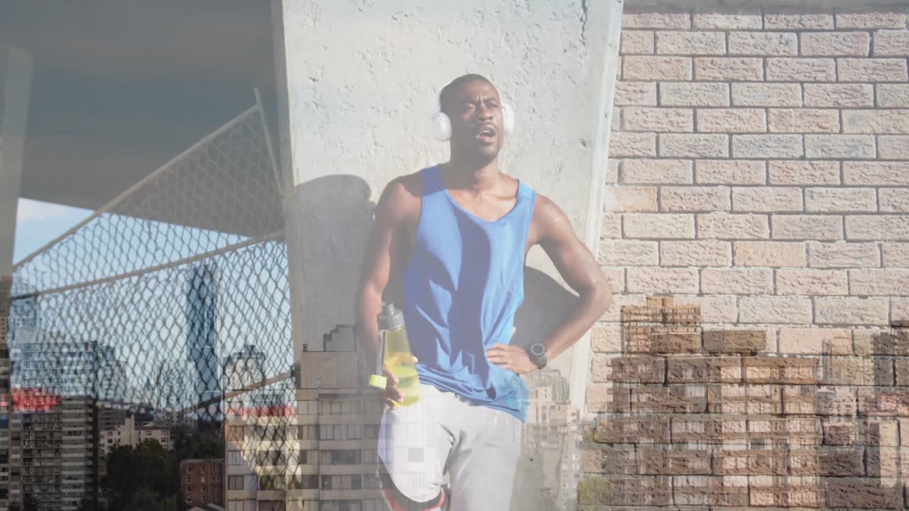 Animation of cityscape over african american man training in headphones having a water break