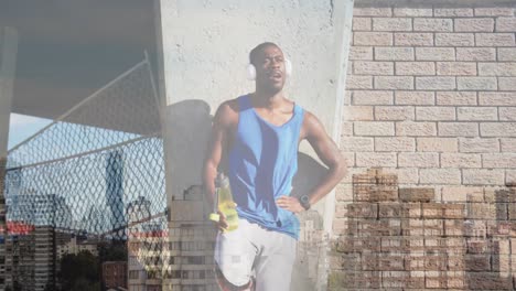 animación del paisaje urbano sobre un hombre afroamericano entrenando en auriculares teniendo un descanso de agua