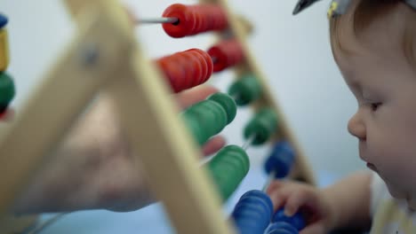 child plays with a multi-colored toy 1