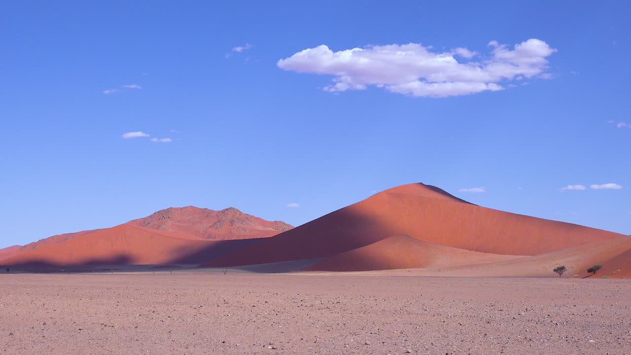 Establishing shot of the Namib Naukluft National park with desert dunes and clouds Namibia