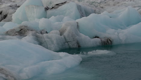 Nahaufnahme-Von-Gletschern,-Die-Im-Eisigen-Wasser-Der-Gletscherlagune-Jökulsárlón-In-Island-Schwimmen