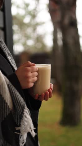 woman enjoying a latte outdoors in autumn