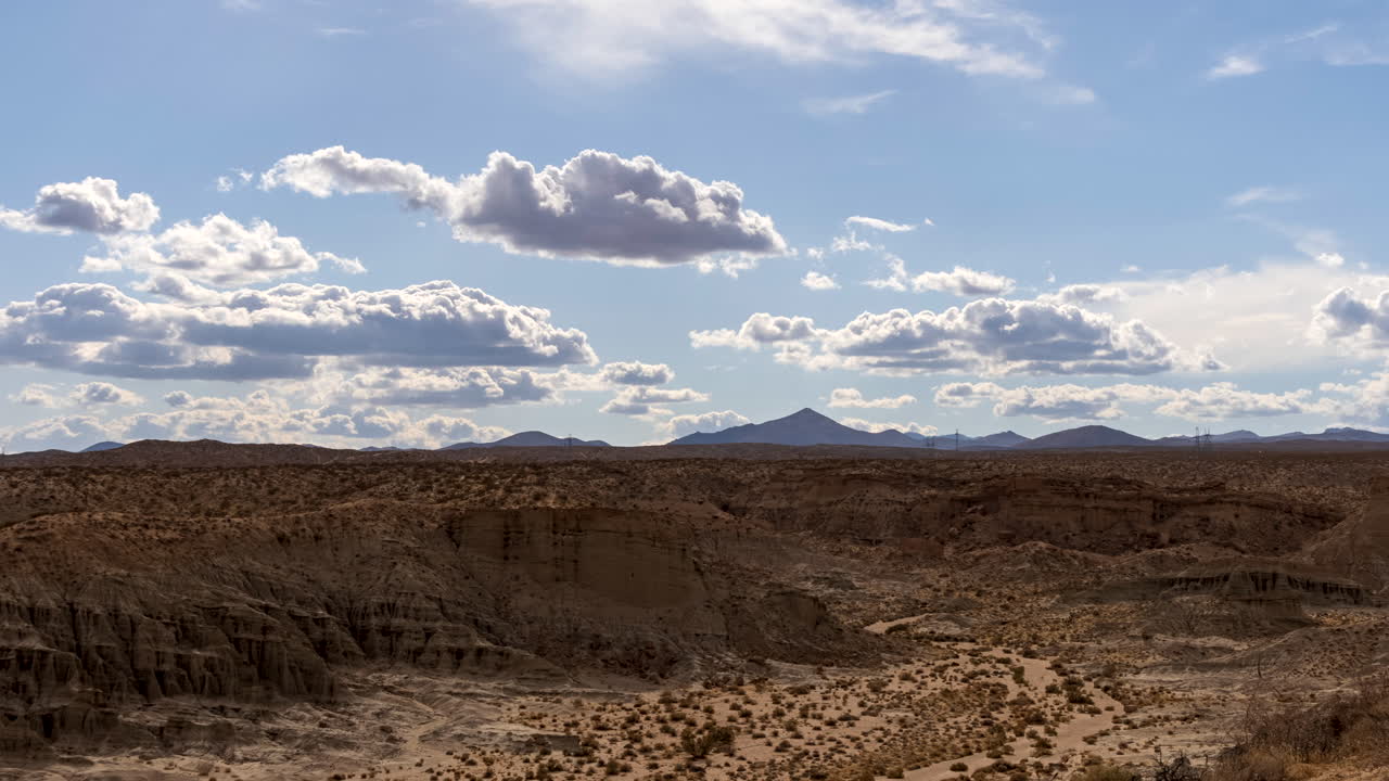 lapso de tiempo panorámico del cañón de roca roja en el desierto de mojave en un caluroso día de verano con nubes ondulantes sobre el terreno accidentado
