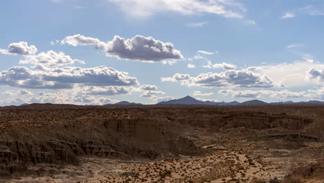 panoramic time lapse of red rock canyon in the mojave desert on a hot summer day with billowing clouds above the rugged terrain