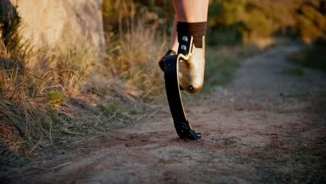 person with prosthetic leg running on a trail