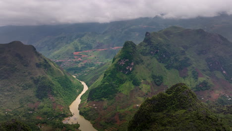 aerial view of nho que river in vietnam, showcasing the winding river surrounded by lush green mountains