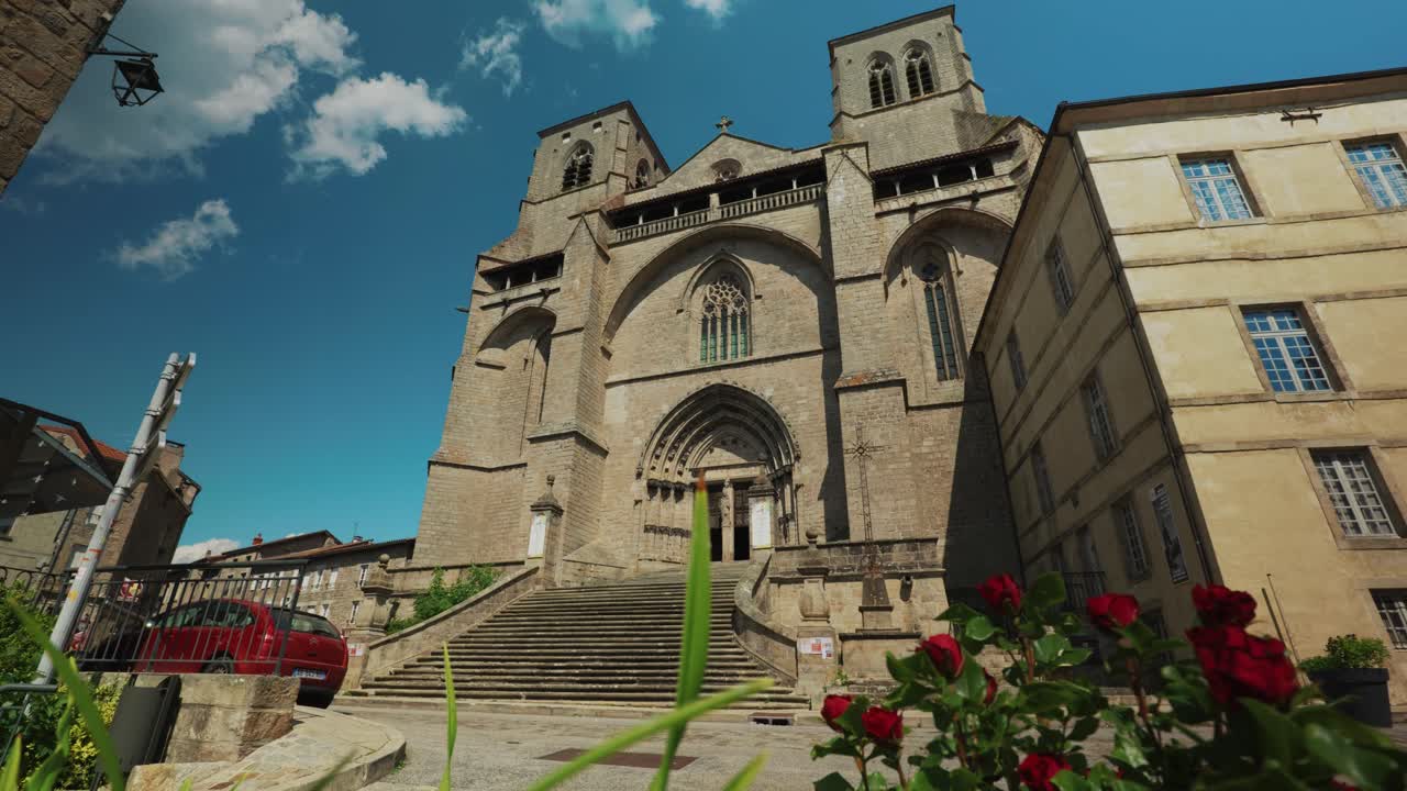wide shot of La Chaise Dieu abbey entrance on a sunny day in La Chaise DIeu, Haute Loire departement, Auvergne Rhone Alpes region, France