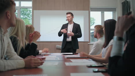 colleagues are listening to top expert in financial analysis and it in business conference confident man