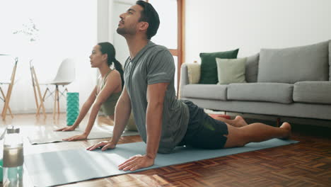 couple, yoga and cobra pose in living room