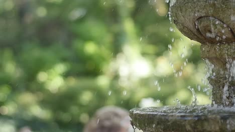 Extreme-Zeitlupe-Von-Wasser,-Das-Aus-Einem-Betonbrunnen-In-Einem-Park-Spritzt