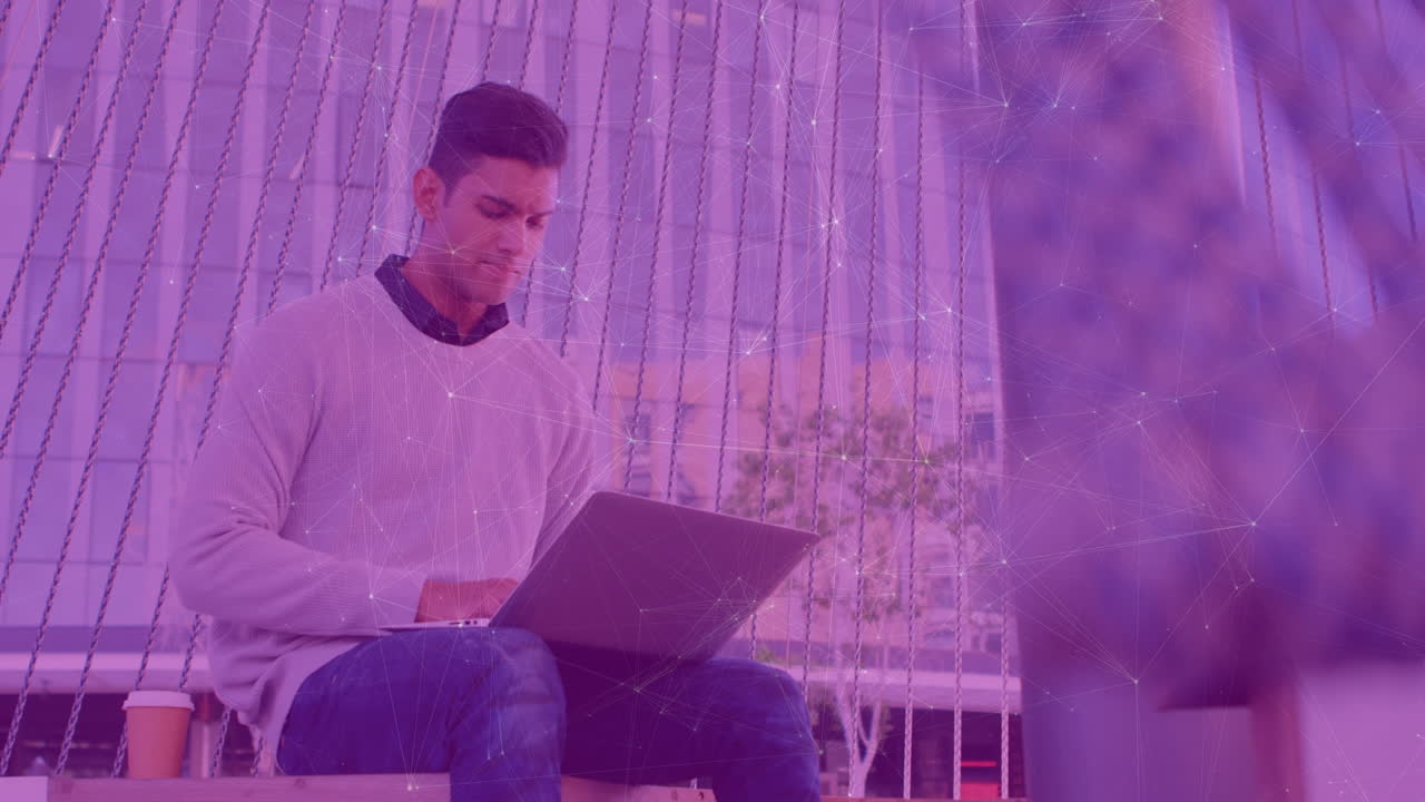 Animation of connections over caucasian man working on laptop