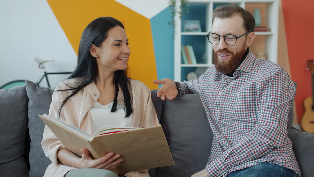 pareja mirando a través del álbum de fotos