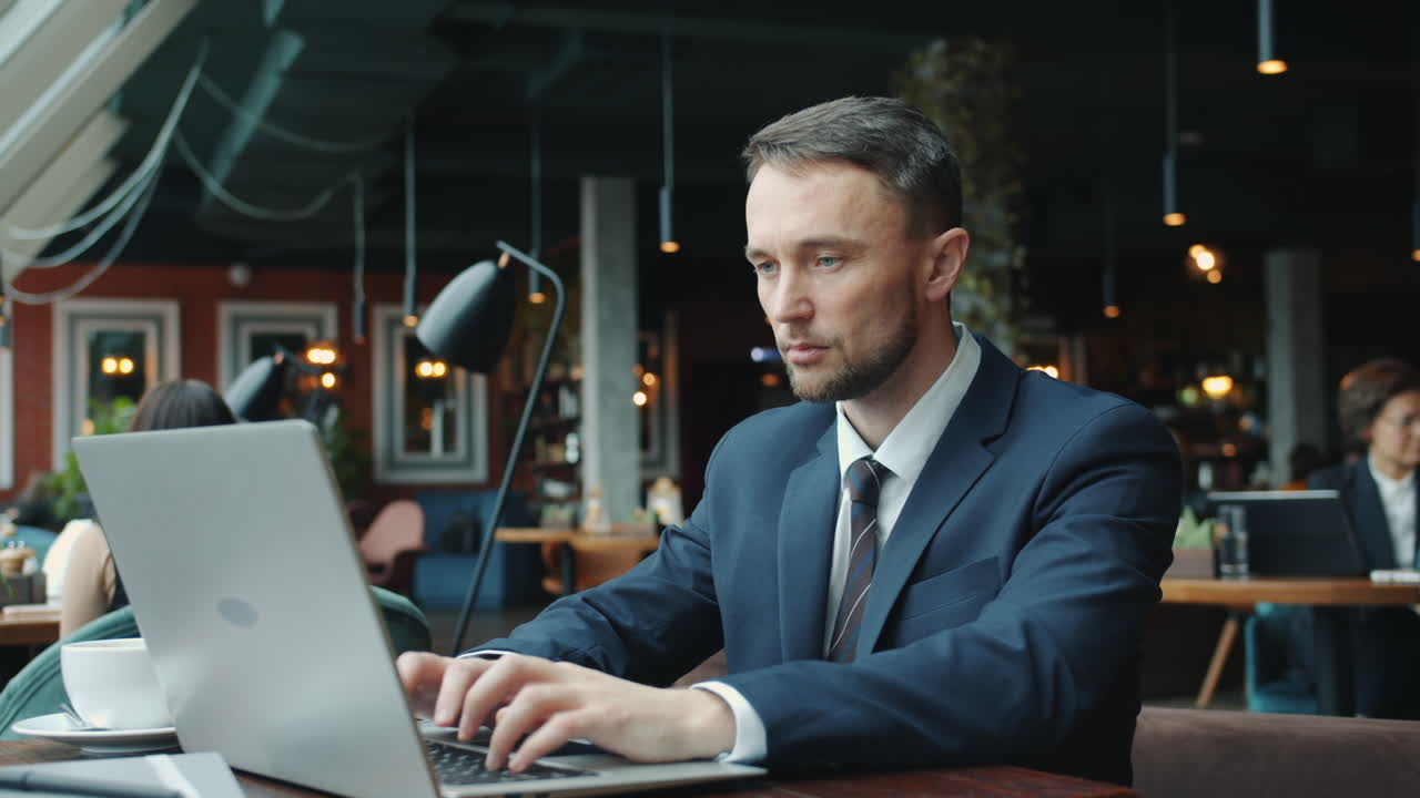 hombre de negocios trabajando en una computadora portátil en un café