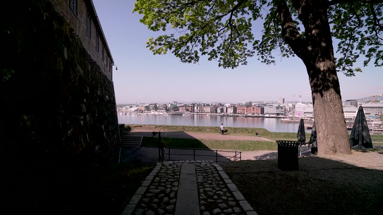 Gimbal shot through a tunnel to reveal view of the harbour from Akershus Fortress of Oslo, Norway.mp4