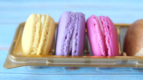 colorful macarons in a gold tray