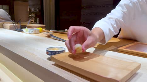 chef skillfully crafts sushi in a restaurant