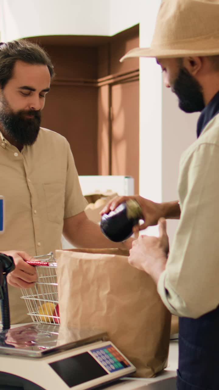 Vertical video Store owner serving client with produce