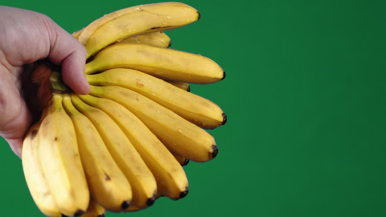 남자 손에 작은 노란 바나나.