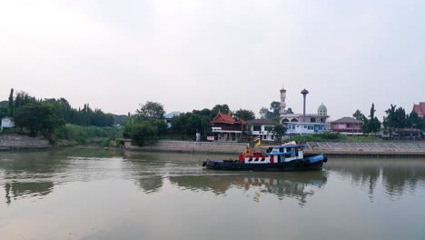 tugboat moving along the river in ayutthaya