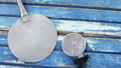 Pizza-peel-and-cutter-on-wooden-table