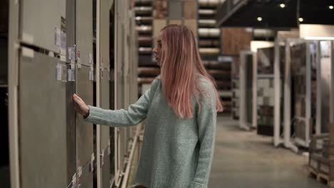 Blond-woman-wearing-face-mask-looking-for-a-tile-in-hardware-store