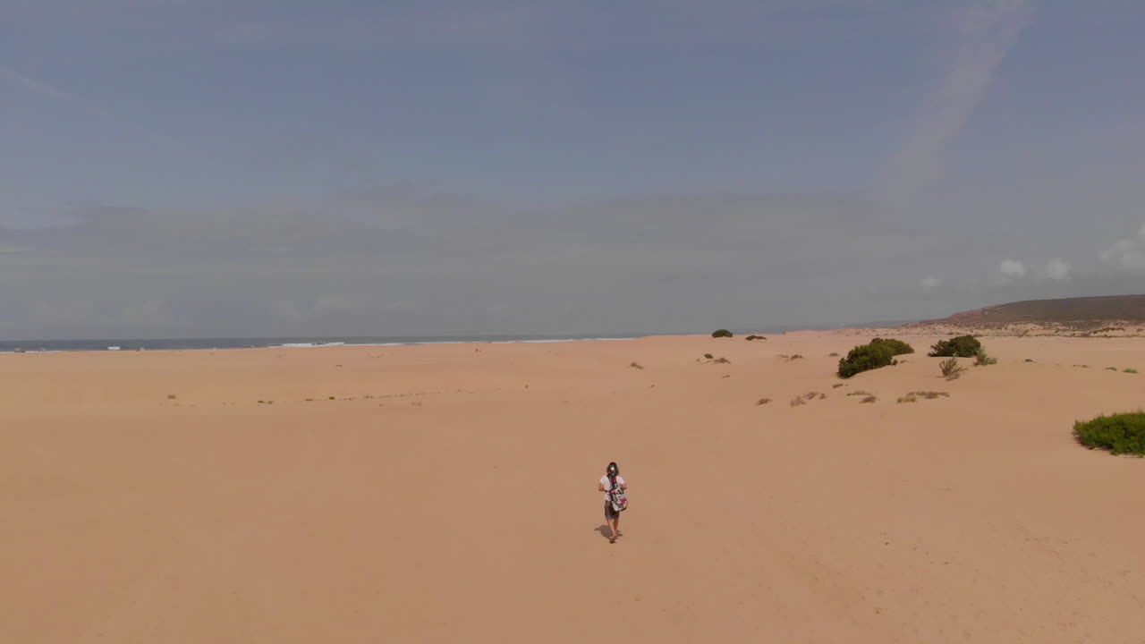 A Lone Girl Walking On The Sandy Beach In Summer At Carrapateira, Algarve, Portugal. Bordeira's Beach- aerial drone shot