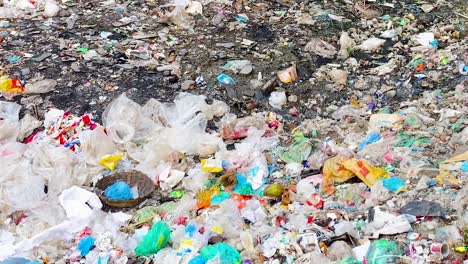 Piles-of-garbage-at-landfill,-panning-view