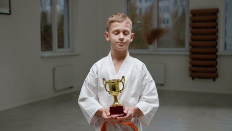 boy in white kimono in martial arts class