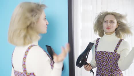 beautiful fun young woman blow-drying her hair in front of the mirror.