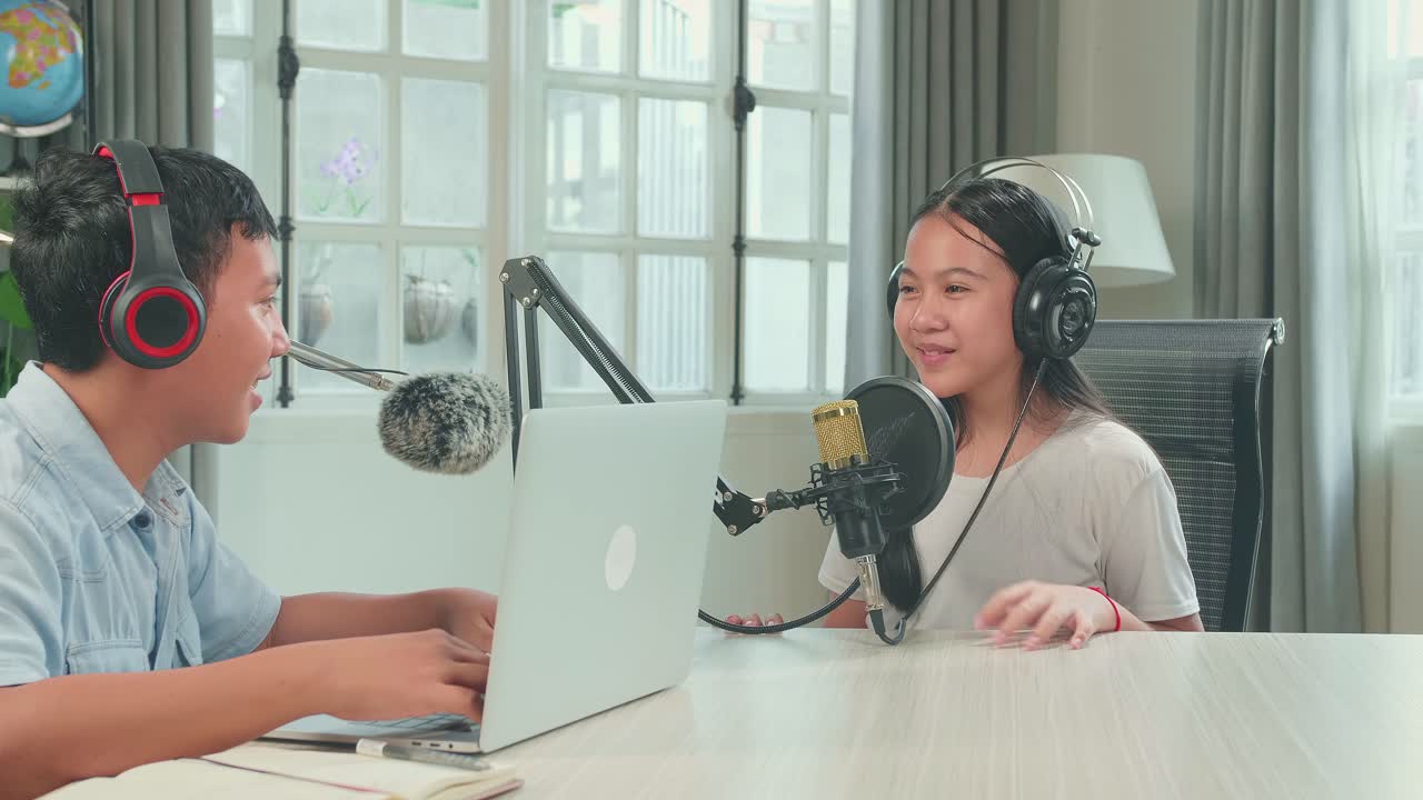 Asian Boy Host Record Podcast Use Microphone Wear Headphone With Laptop Interview Guest Conversation For Content In His Home Studio. Content Creator Concept