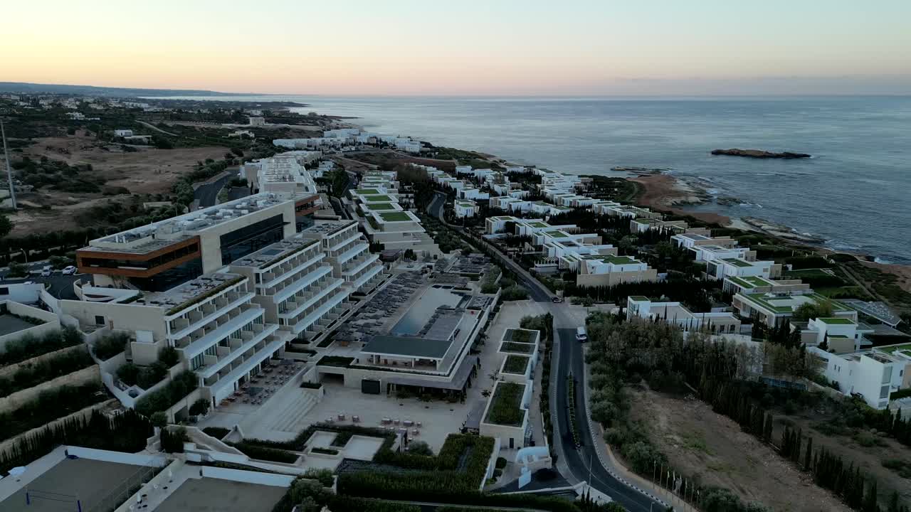 Close-up drone capture of terraced homes with private pools, each overlooking the ocean and offering stunning, uninterrupted views of the coastline.