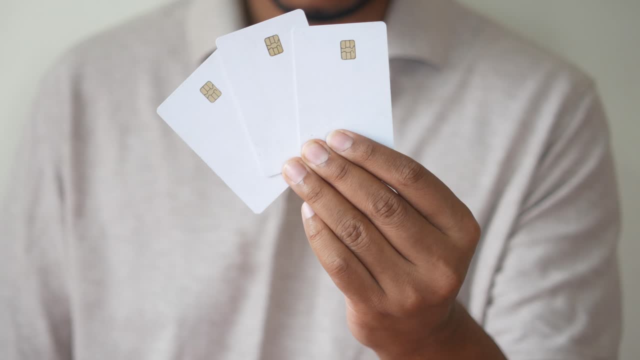 Hand holding multiple blank credit cards