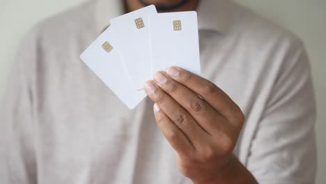 hand holding multiple blank credit cards