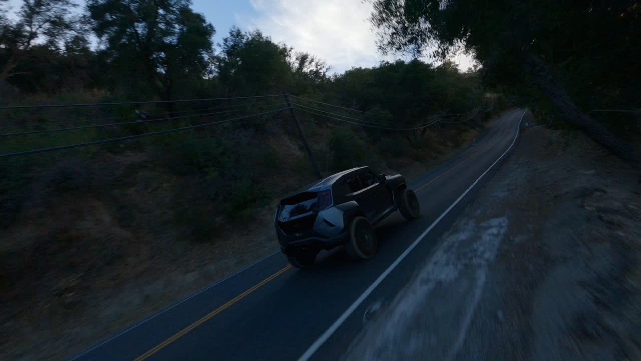 toma fpv de auto negro conduciendo rápido en la carretera por la mañana