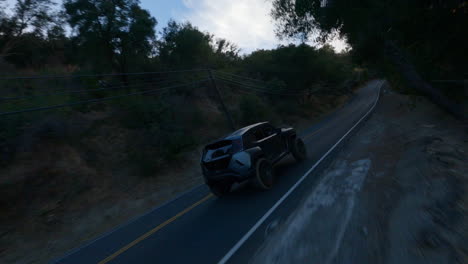 fpv shot of black car driving fast on road at morning