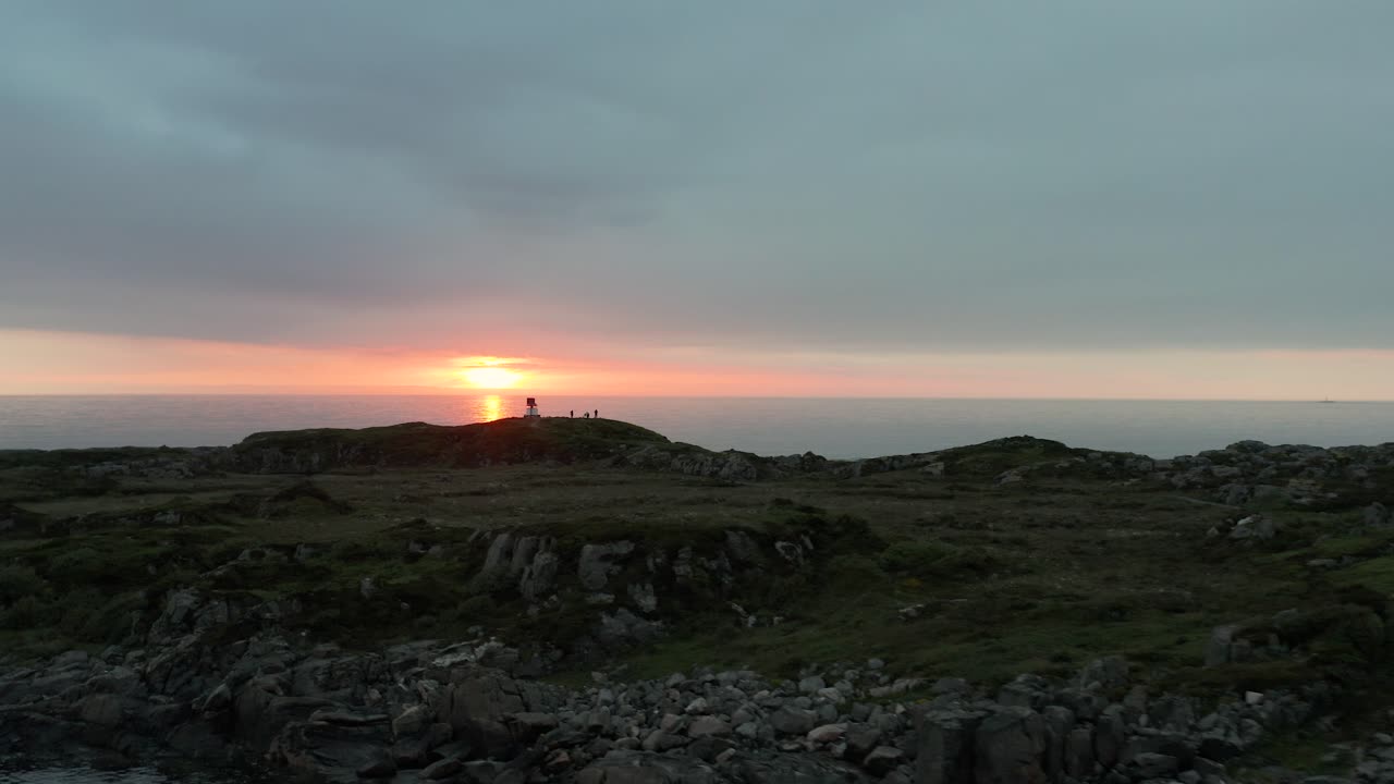 오렌지색 빛의 광선이 노르웨이의 farstad strand 해변에서 해가 지는 동안 물을 가로질러 반사되는 바다 물에 대한 공중 도리