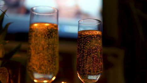 close up of two glasses of champagne with bubbles rising