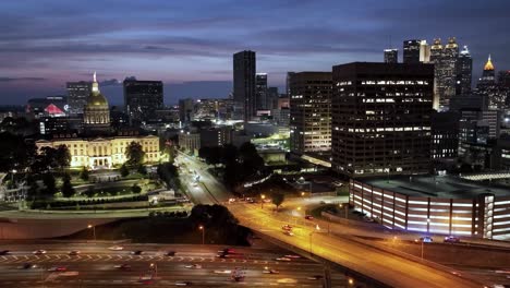 Georgia-state-capitol-building-in-Atlanta,-Georgia-at-night-with-drone-video-moving-in-a-hyperlapse