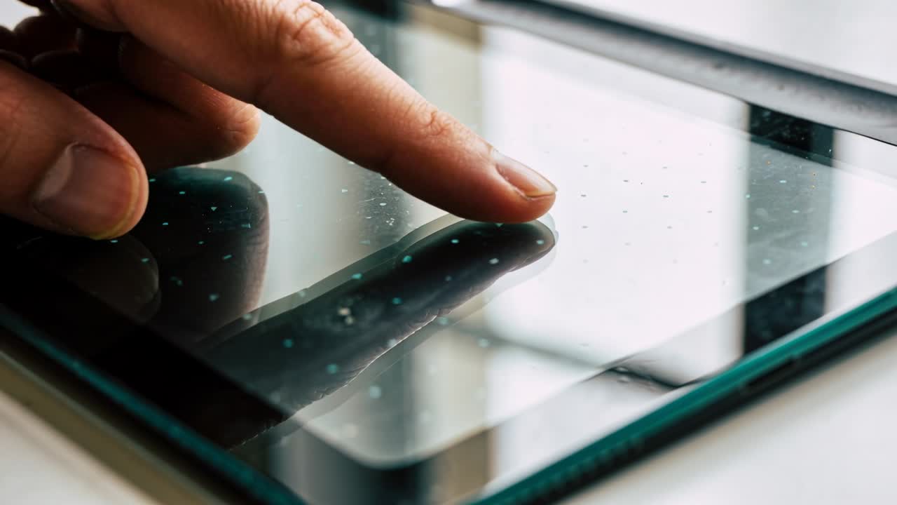 Touching finger approaching, sliding across tablet near window, scrolling content with teal case