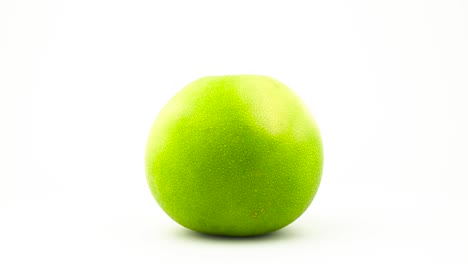 one whole green sweetie fruit with water drops. rotating. isolated on the white background. close-up. macro.