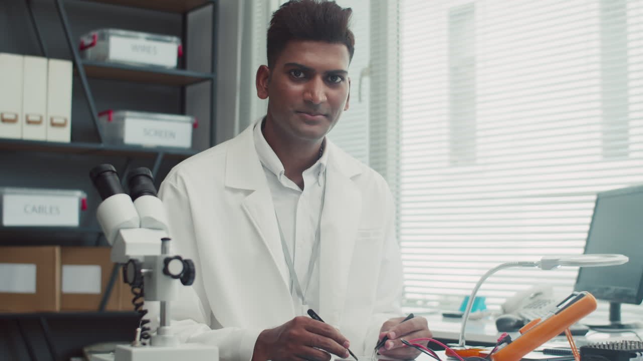 Cheerful Mobile Phones Repairman Looking at Camera