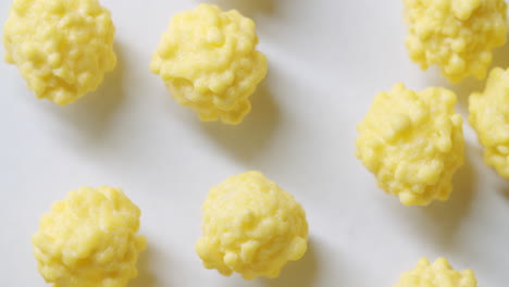 macro shot of yellow virus cells on a white surface with light form the left